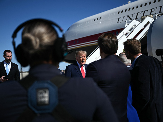 US President Donald Trump speaks to members of the press before boarding Air Force One at Joint Base Andrews, Maryland on October 25, 2026. President Trump is travelling to Michigan to speak at a midterm election rally. (Photo by Brendan SMIALOWSKI / AFP via Getty Images)