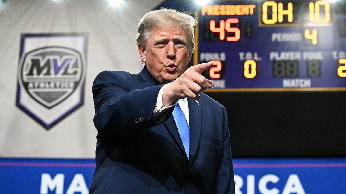 President Donald Trump takes the stage at a podium during a campaign rally in Vandalia, Ohio.